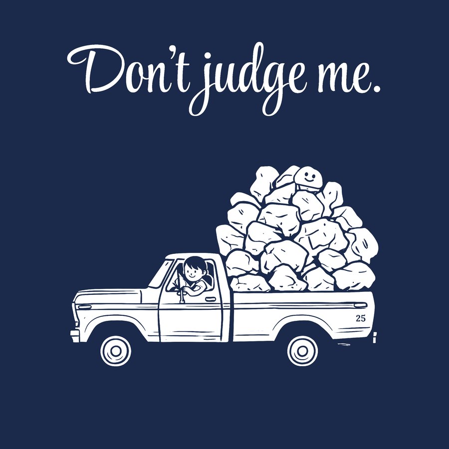 A pickup truck with a bed piled high with rocks, Skip riding on top. Don't judge me.