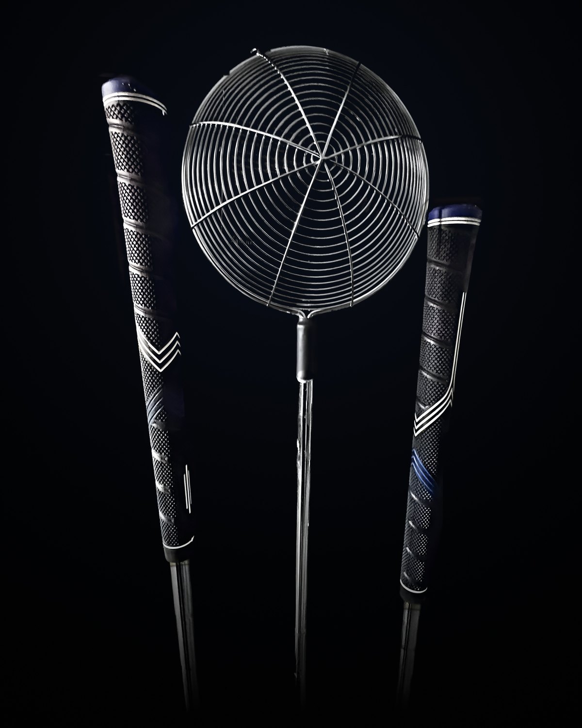 The large Rock Sift between two golf grips